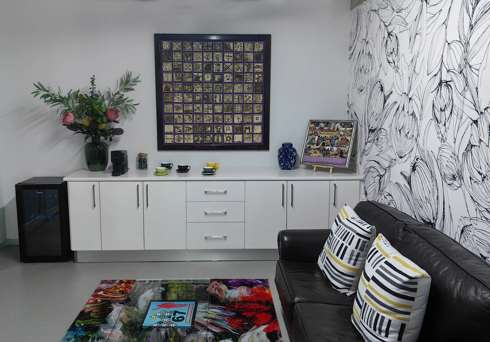 The Spectrum team's clay tile mosaic, mounted in our reception area